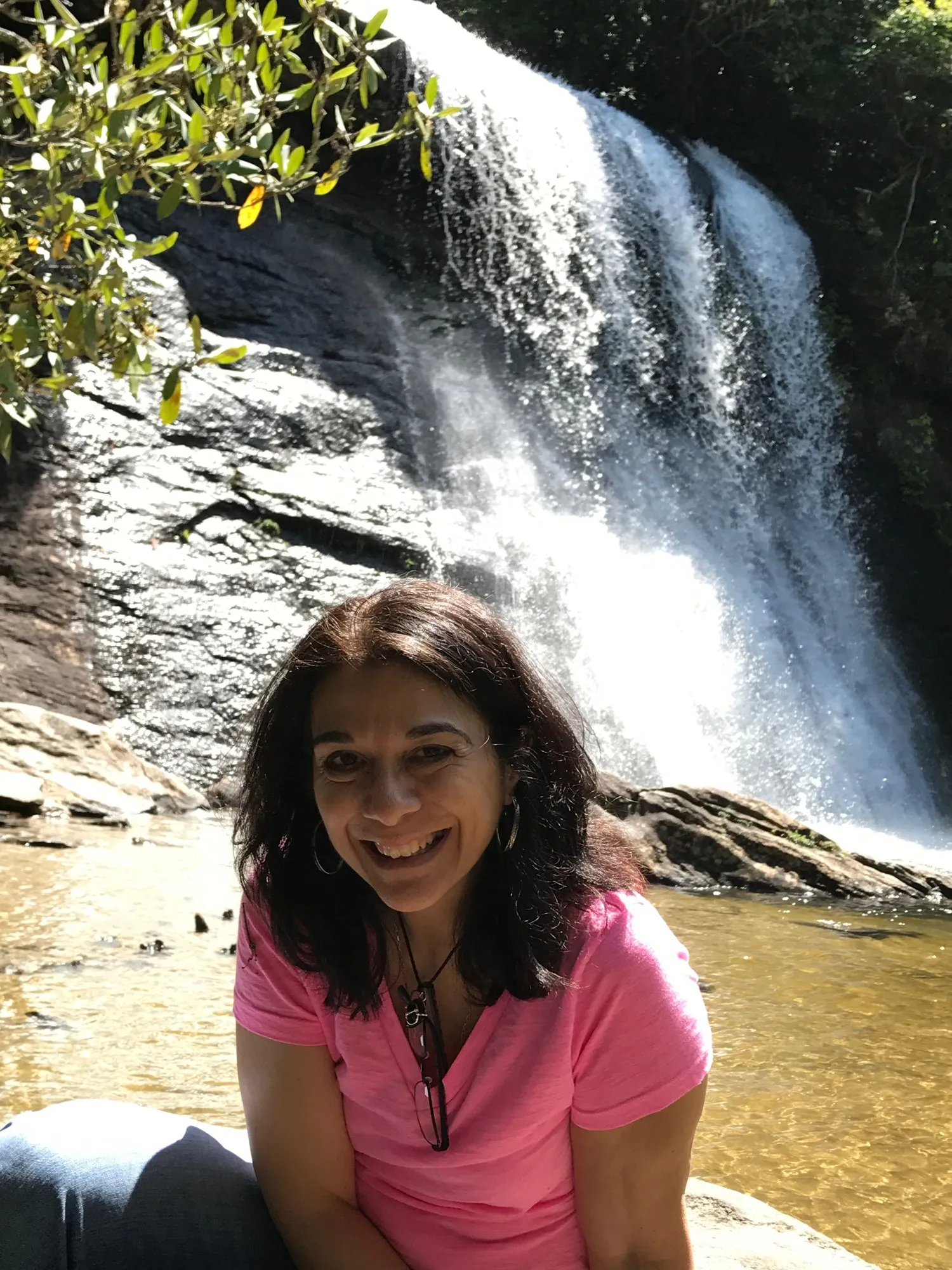 Mary Bondi smiling by a waterfall