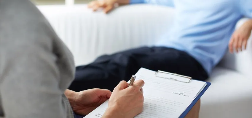 Therapist taking notes during a counseling session